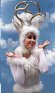 An event performer dressed in a white reindeer costume that has delicate feathered accents.